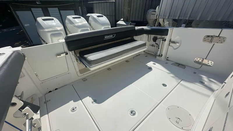  Yacht Photos Pics 2014 Boston Whaler 350 Outrage boat deck with seating and triple outboard engines.