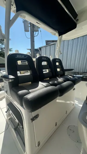  Yacht Photos Pics 2014 Boston Whaler 350 Outrage boat interior with black cushioned seating.
