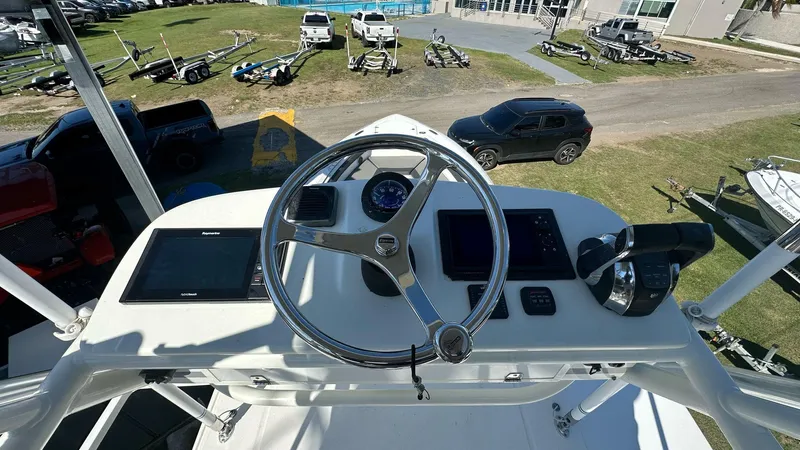  Yacht Photos Pics 2014 Boston Whaler 350 Outrage helm with steering wheel and navigation controls.