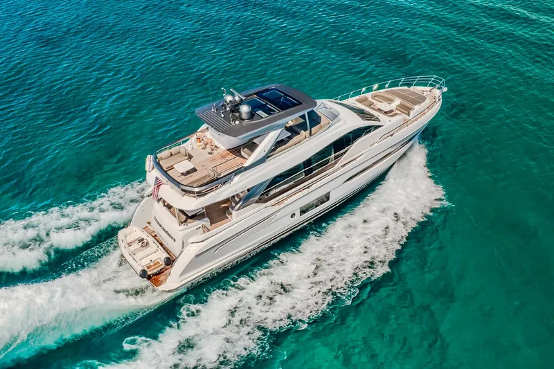 Transcendence Yacht Photos Pics Luxurious 2020 Azimut 78 Flybridge yacht cruising on clear blue waters.