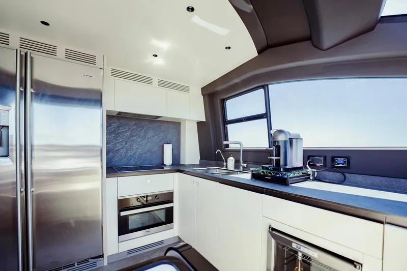 Transcendence Yacht Photos Pics Modern kitchen interior on 2020 Azimut 78 Flybridge yacht, featuring sleek appliances and ocean view.