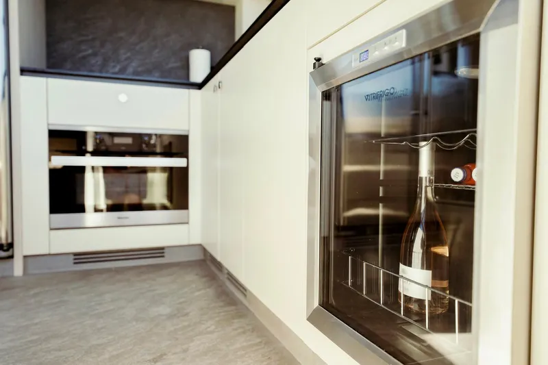 Transcendence Yacht Photos Pics Modern kitchen interior on 2020 Azimut 78 Flybridge yacht with wine cooler and oven.