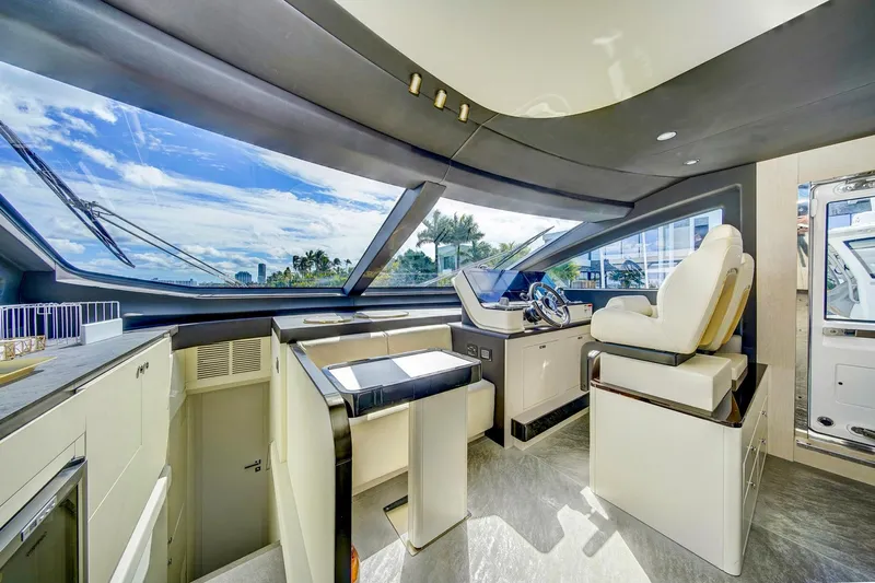 Transcendence Yacht Photos Pics Luxurious interior of 2020 Azimut 78 Flybridge yacht with modern helm and panoramic windows.