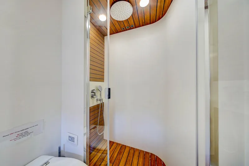 Transcendence Yacht Photos Pics Luxurious shower area in 2020 Azimut 78 Flybridge yacht with wooden accents.