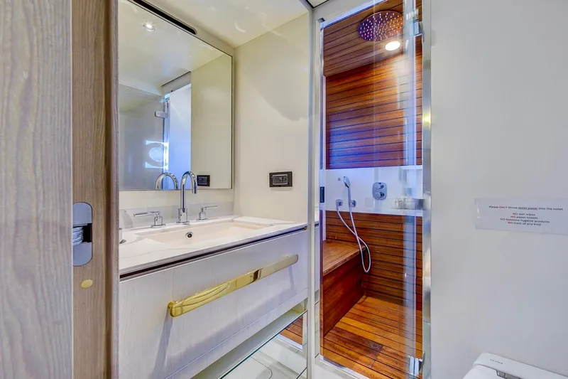 Transcendence Yacht Photos Pics Luxurious bathroom in 2020 Azimut 78 Flybridge yacht with modern fixtures and wooden accents.
