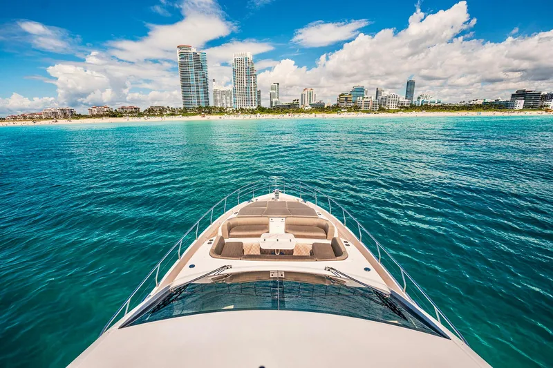 Transcendence Yacht Photos Pics Azimut 78 Flybridge yacht cruising near a vibrant city skyline, 2020 model.