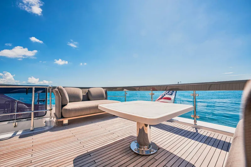 Transcendence Yacht Photos Pics Azimut 78 Flybridge 2020 yacht deck with seating, table, and ocean view.
