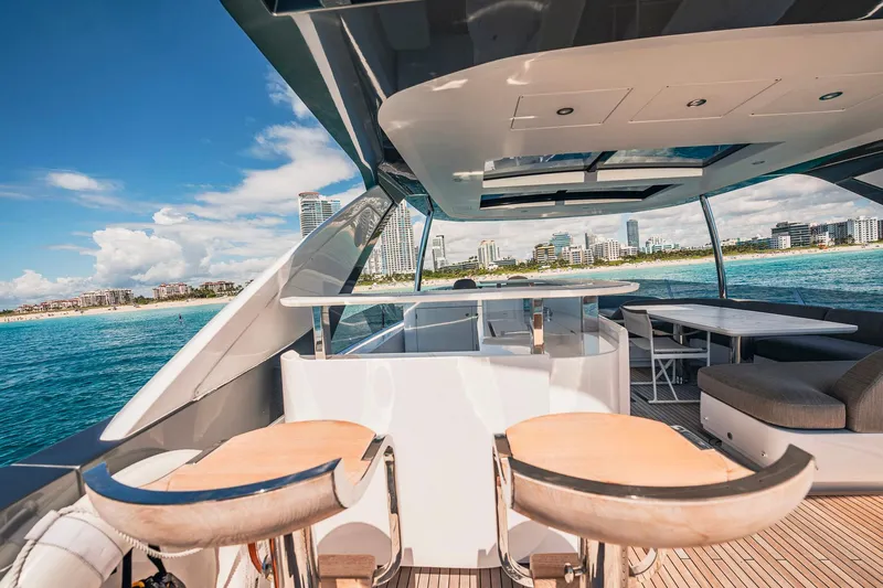 Transcendence Yacht Photos Pics Luxurious 2020 Azimut 78 Flybridge yacht with modern seating, ocean view, and city skyline.