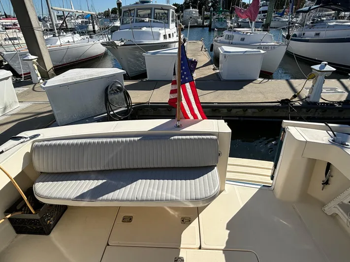 Bay Cruzin Yacht Photos Pics 2004 Mainship Pilot 34 Rum Runner II Hardtop at marina with American flag.