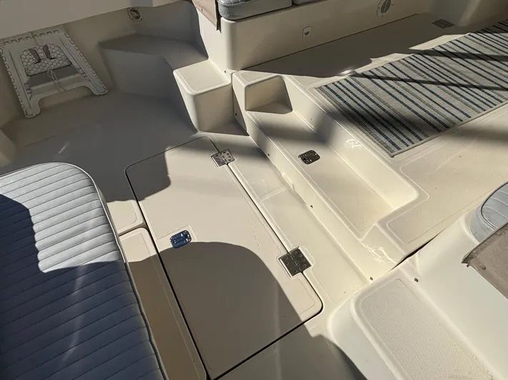 Bay Cruzin Yacht Photos Pics 2004 Mainship Pilot 34 Rum Runner II Hardtop boat interior with seating and storage compartments.