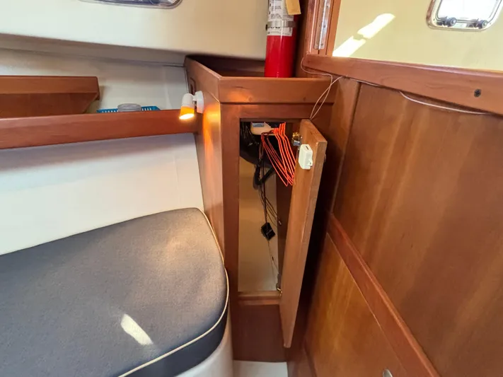 Bay Cruzin Yacht Photos Pics 2004 Mainship Pilot 34 Rum Runner II interior with open cabinet and fire extinguisher.