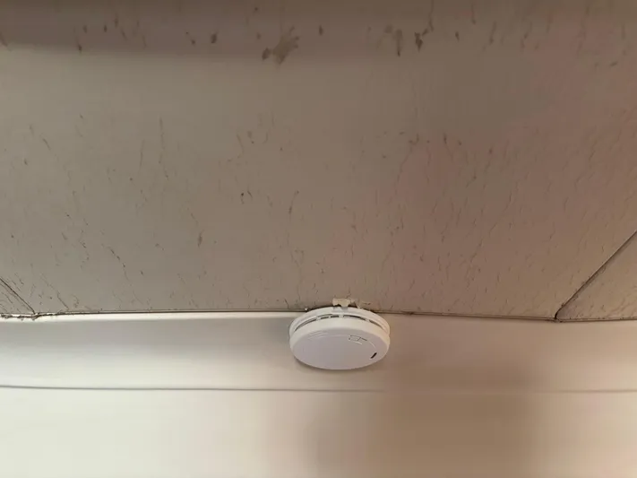 Bay Cruzin Yacht Photos Pics Ceiling-mounted smoke detector on a 2004 Mainship Pilot 34 Rum Runner II Hardtop.