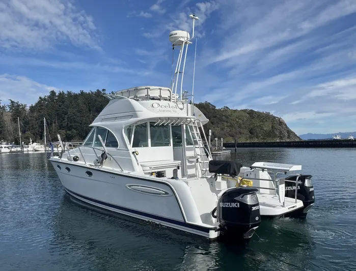 Ocelot Yacht Photos Pics 2005 Glacier Bay 3490 Ocean Runner boat with Suzuki engines on calm water.