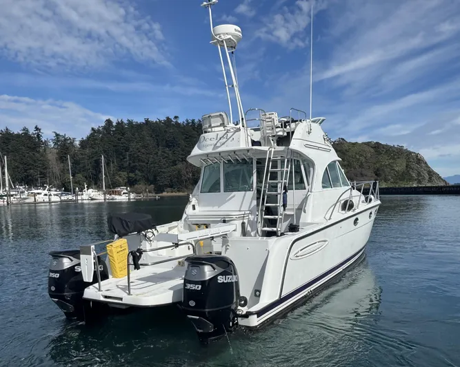 Ocelot Yacht Photos Pics 2005 Glacier Bay 3490 Ocean Runner boat docked in scenic marina.