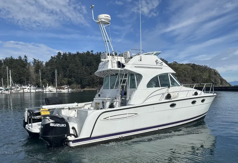Ocelot Yacht Photos Pics 2005 Glacier Bay 3490 Ocean Runner boat on water, with Suzuki outboard motor.