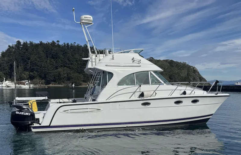 Ocelot Yacht Photos Pics 2005 Glacier Bay 3490 Ocean Runner boat on calm water, scenic background.