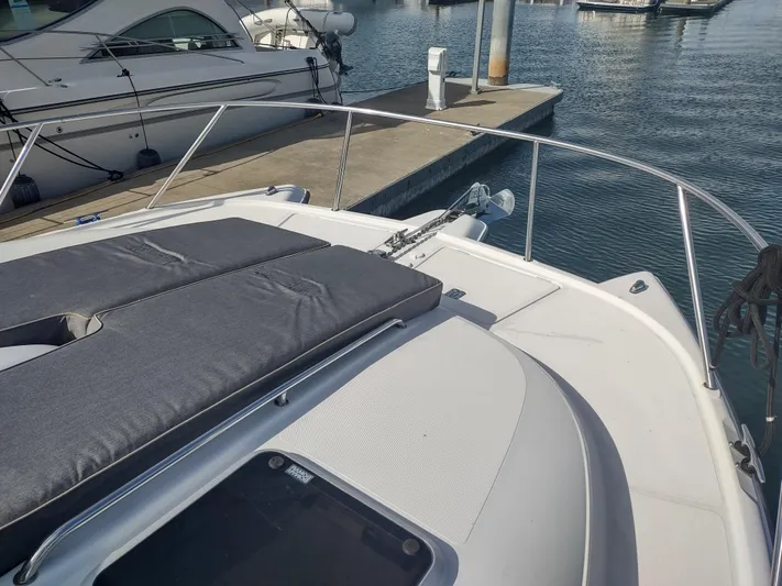 Ocelot Yacht Photos Pics 2005 Glacier Bay 3490 Ocean Runner boat docked at marina, featuring spacious deck.