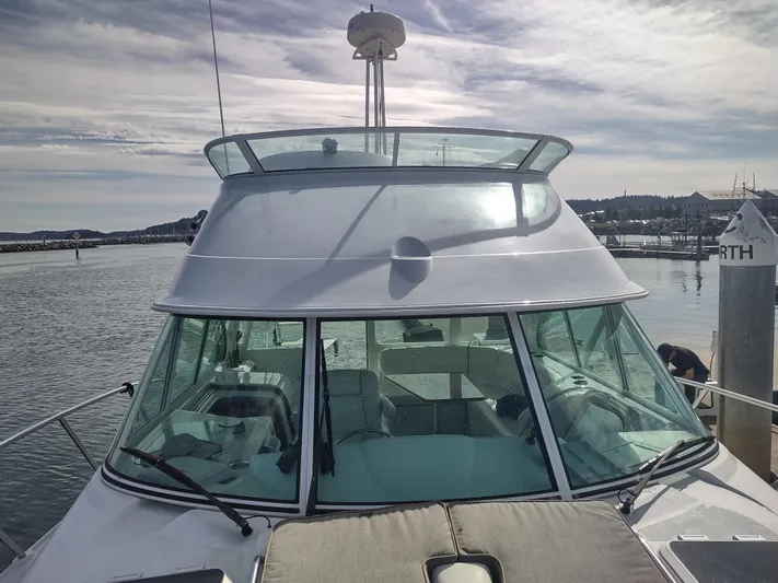 Ocelot Yacht Photos Pics 2005 Glacier Bay 3490 Ocean Runner boat docked at marina under cloudy sky.