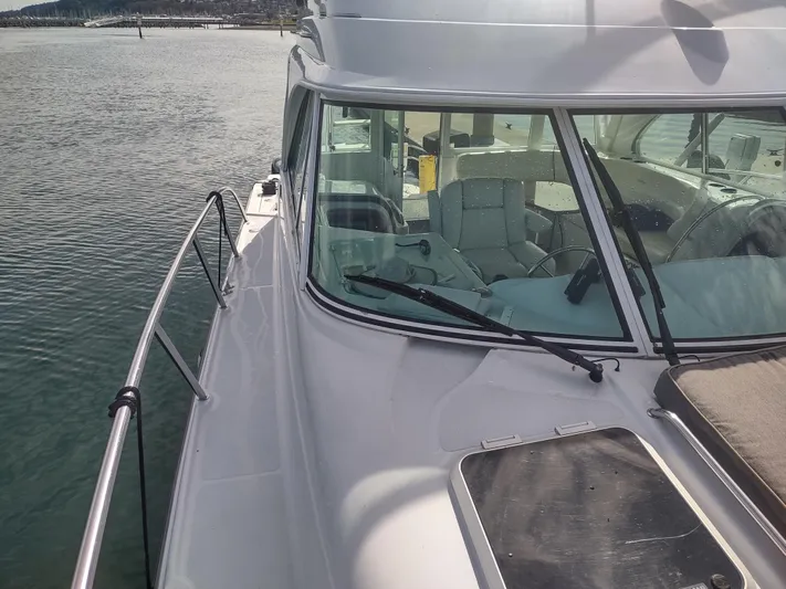 Ocelot Yacht Photos Pics 2005 Glacier Bay 3490 Ocean Runner boat on calm water, side view of cabin and deck.