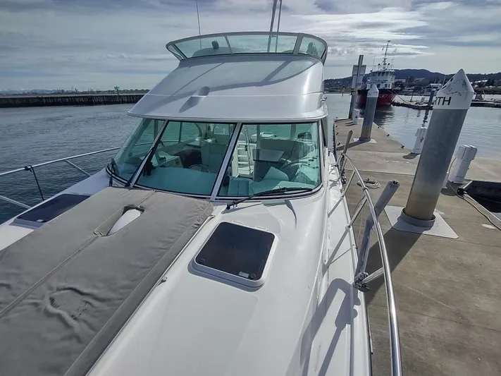 Ocelot Yacht Photos Pics 2005 Glacier Bay 3490 Ocean Runner docked at a marina, showcasing sleek design and spacious deck.