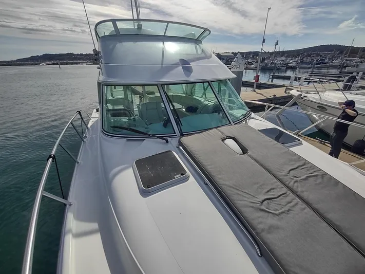 Ocelot Yacht Photos Pics 2005 Glacier Bay 3490 Ocean Runner boat docked at marina under cloudy sky.