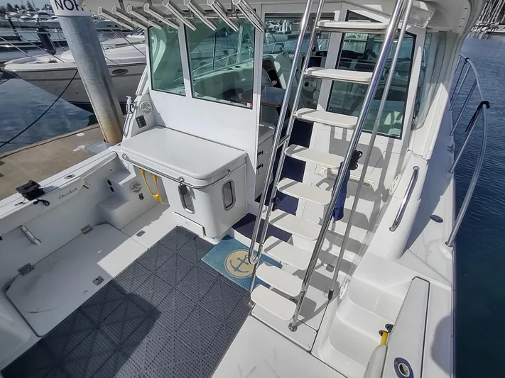 Ocelot Yacht Photos Pics 2005 Glacier Bay 3490 Ocean Runner boat interior with ladder and fishing equipment.