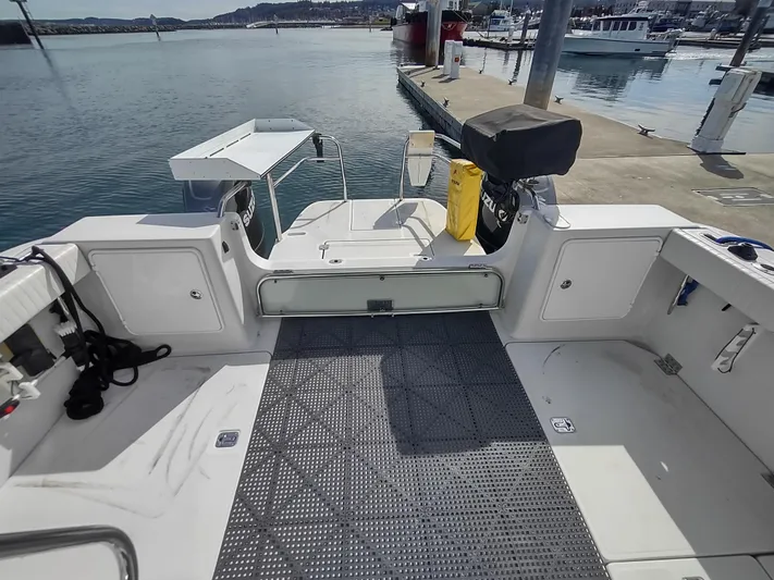 Ocelot Yacht Photos Pics 2005 Glacier Bay 3490 Ocean Runner boat docked at marina, featuring spacious deck area.