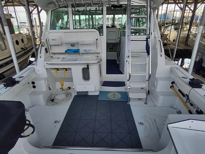 Ocelot Yacht Photos Pics 2005 Glacier Bay 3490 Ocean Runner boat interior with fishing equipment and seating area.