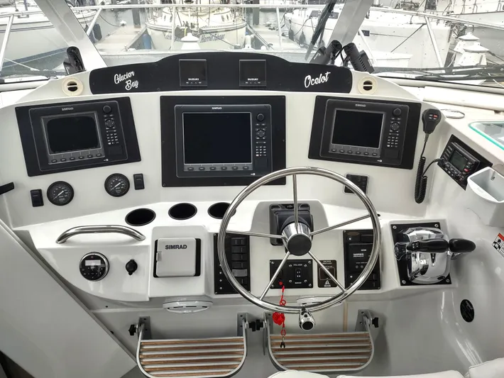 Ocelot Yacht Photos Pics Helm of 2005 Glacier Bay 3490 Ocean Runner with navigation instruments and steering wheel.