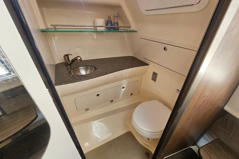 Day For It Yacht Photos Pics 2018 Boston Whaler 315 Conquest bathroom with sink, toilet, and storage.