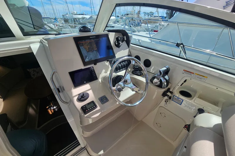Day For It Yacht Photos Pics 2018 Boston Whaler 315 Conquest helm with navigation screens and steering wheel.
