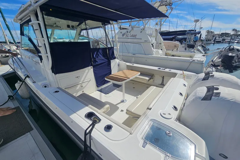 Day For It Yacht Photos Pics 2018 Boston Whaler 315 Conquest docked, featuring spacious deck and seating area.