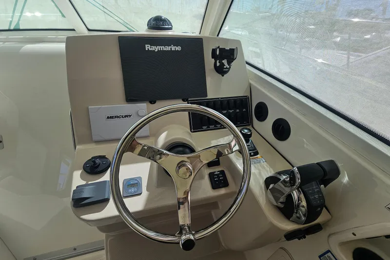 Day For It Yacht Photos Pics Helm of 2018 Boston Whaler 315 Conquest with Raymarine electronics and Mercury controls.