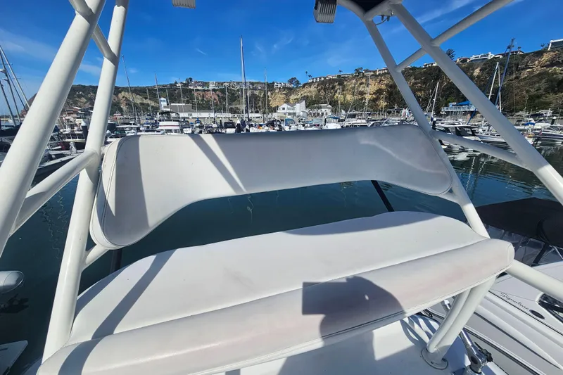 Day For It Yacht Photos Pics 2018 Boston Whaler 315 Conquest boat seating area in a marina setting.