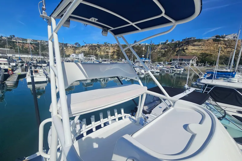 Day For It Yacht Photos Pics 2018 Boston Whaler 315 Conquest boat docked in a scenic marina.