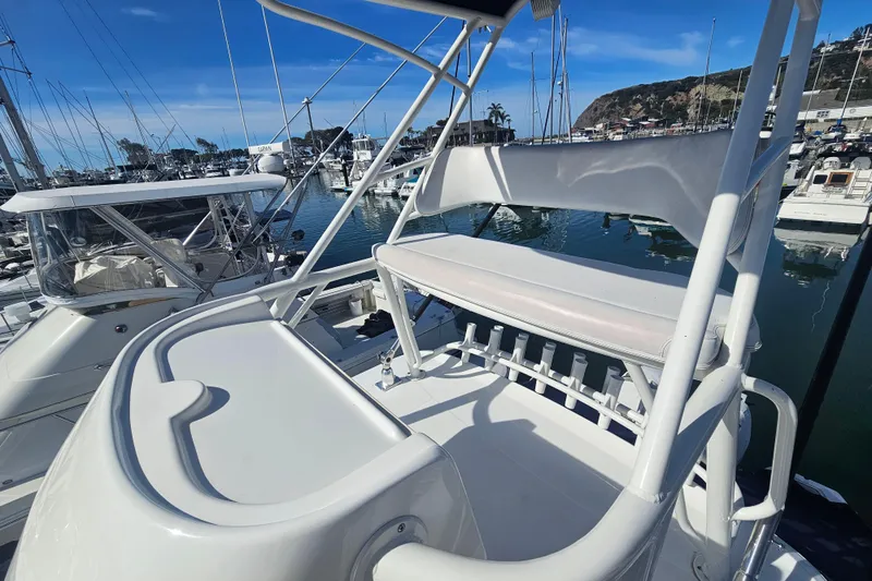 Day For It Yacht Photos Pics 2018 Boston Whaler 315 Conquest boat docked in a marina, featuring upper deck seating.