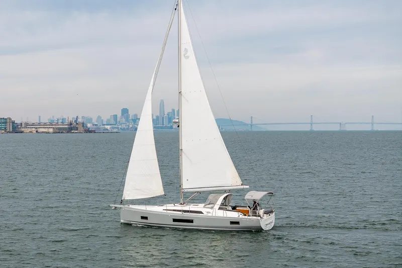 Cypress And Star II Yacht Photos Pics 2020 Beneteau Oceanis 46.1 sailing near city skyline and bridge.