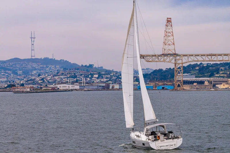 Cypress And Star II Yacht Photos Pics Sailing yacht Beneteau Oceanis 46.1, 2020 model, cruising near a cityscape and bridge.