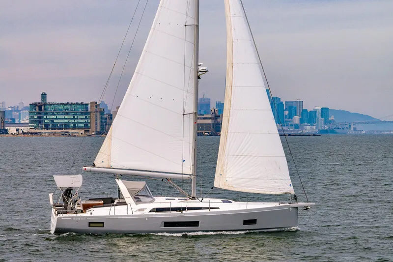 Cypress And Star II Yacht Photos Pics 2020 Beneteau Oceanis 46.1 sailing near city skyline, showcasing sleek design and spacious deck.