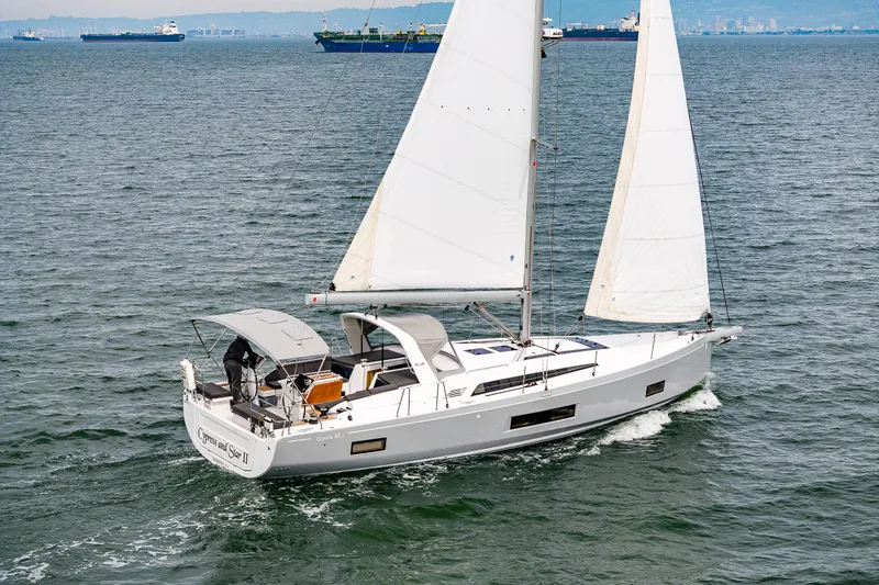 Cypress And Star II Yacht Photos Pics 2020 Beneteau Oceanis 46.1 sailing on open water, showcasing sleek design and white sails.