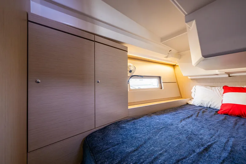 Cypress And Star II Yacht Photos Pics Cozy cabin interior of 2020 Beneteau Oceanis 46.1 yacht with bed and storage.