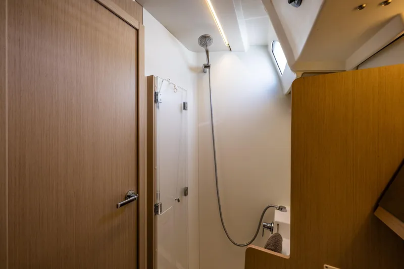 Cypress And Star II Yacht Photos Pics Bathroom interior of 2020 Beneteau Oceanis 46.1 yacht, featuring modern shower and wooden finishes.