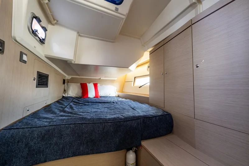Cypress And Star II Yacht Photos Pics Cozy cabin interior of 2020 Beneteau Oceanis 46.1 with bed and storage.