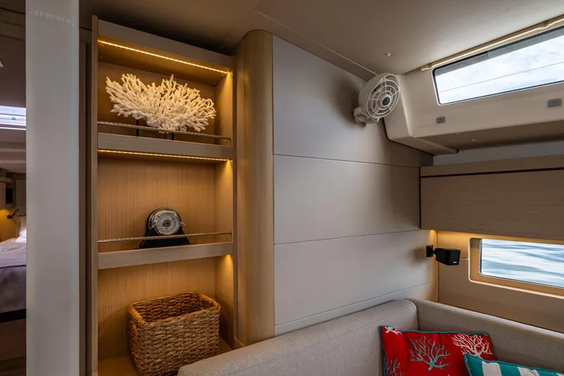 Cypress And Star II Yacht Photos Pics Interior of 2020 Beneteau Oceanis 46.1 yacht with elegant shelving and coral decor.