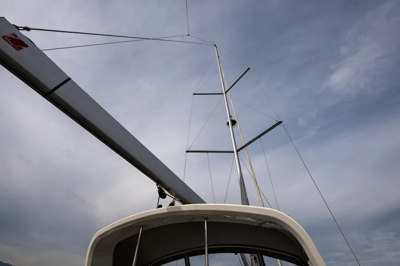 Cypress And Star II Yacht Photos Pics 2020 Beneteau Oceanis 46.1 sailboat mast against a cloudy sky.