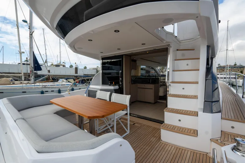 Yacht Photos Pics 2022 Azimut Fly 53 yacht with outdoor seating and staircase, docked at marina.