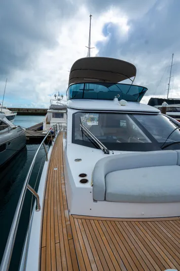  Yacht Photos Pics 2022 Azimut Fly 53 yacht with sleek design and wooden deck, docked at marina.
