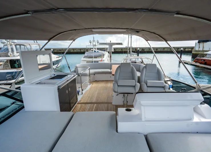  Yacht Photos Pics Luxurious 2022 Azimut Fly 53 yacht interior with seating and kitchenette, docked at marina.