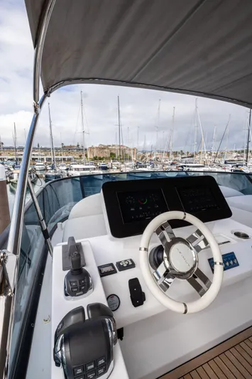  Yacht Photos Pics 2022 Azimut Fly 53 yacht helm with modern controls, docked in a marina.