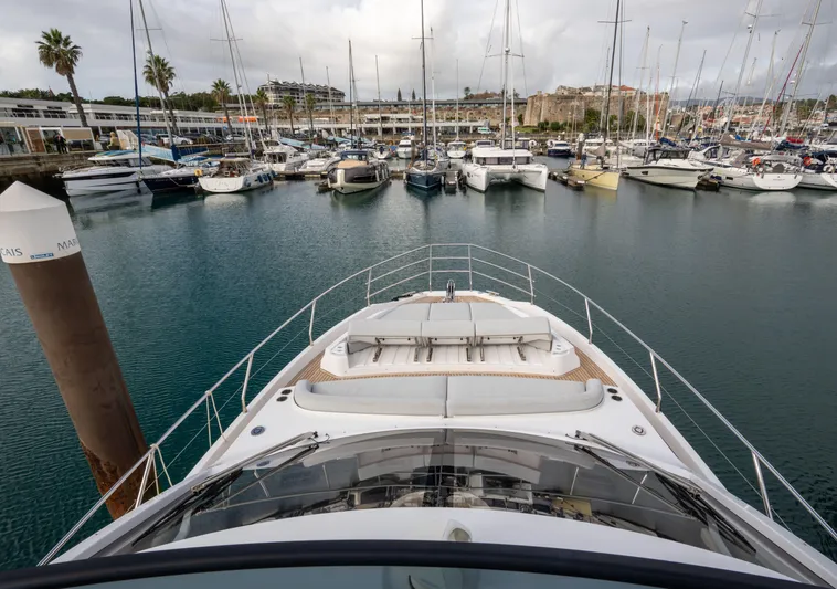  Yacht Photos Pics Azimut Fly 53 yacht docked in a marina, surrounded by sailboats, 2022 model.